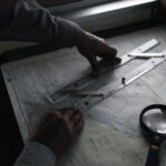 man measuring distance on map