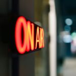 illuminated on air sign in studio setting