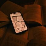 digital age reading phone amidst books