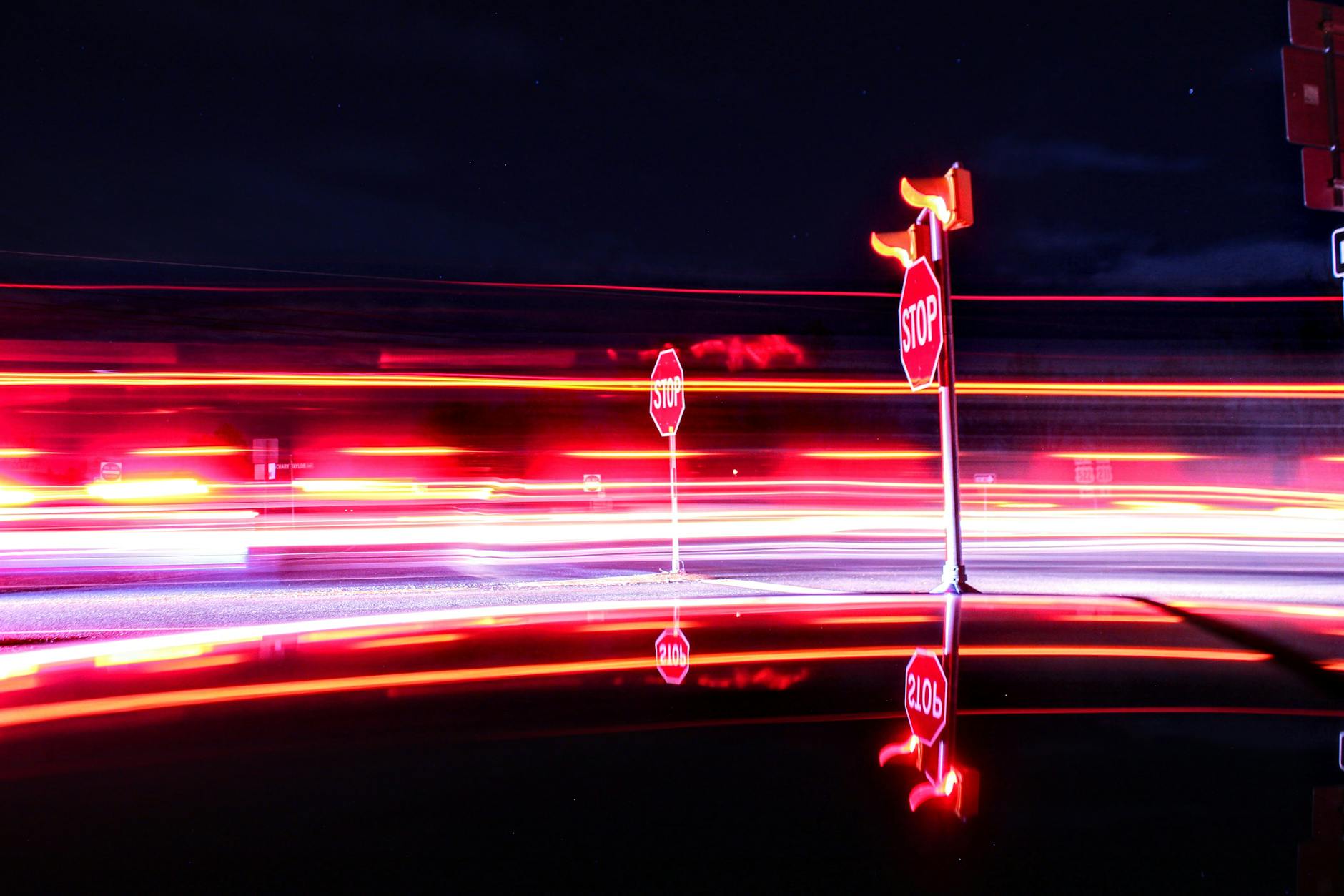 dynamic light trails around stop signs at night